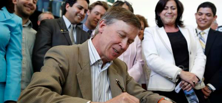 Gov. John Hickenlooper signing a bill into law in 2013.