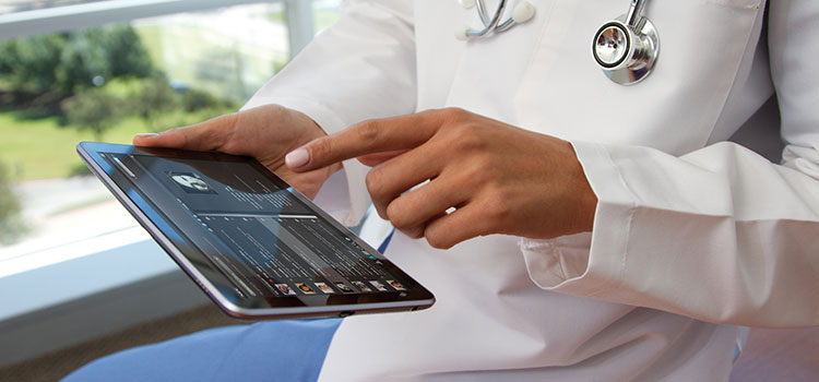 A doctor organizing their work via a touchscreen tablet.