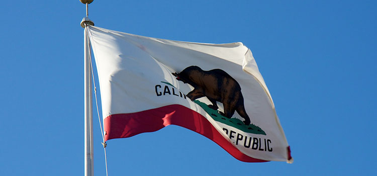 The flag of California flying in the wind.