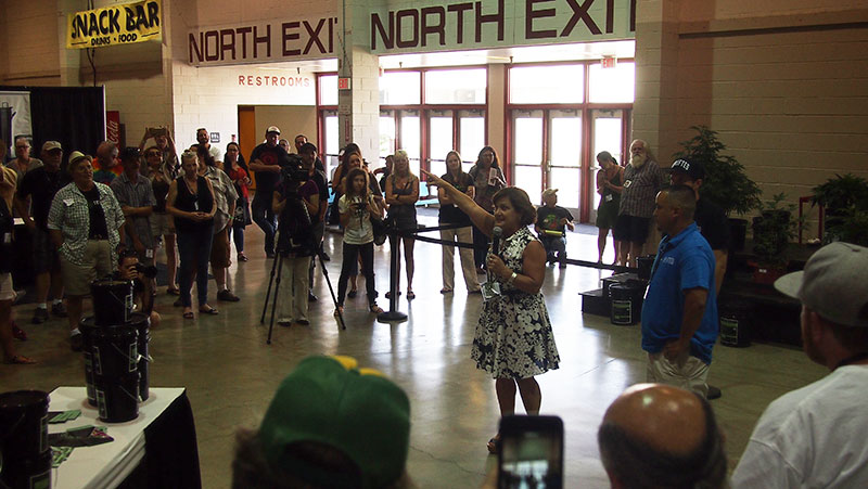 Event organizer Mary Lou Burton addresses the crowd before Ed Rosenthal announces the nine winning cannabis cultivators.