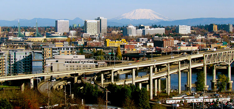 Skyline view of Portland, Oregon, with snow-capped Mt. Hood on the eastern horizon.