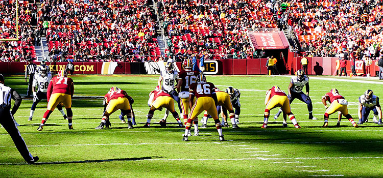 Football players lined up to hike the ball.