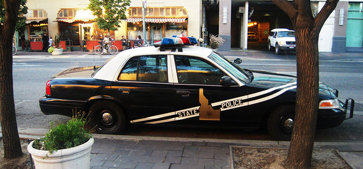 An Idaho state police car parked on the side of the street.