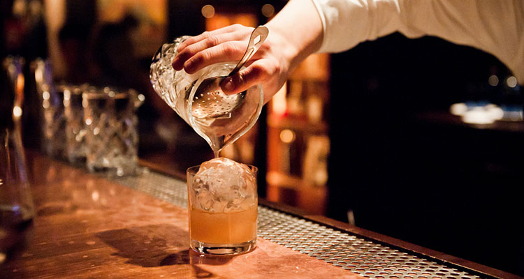 A bartender prepares a cocktail.