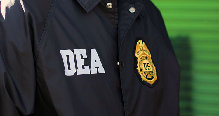DEA patch and badge on an officer's coat.