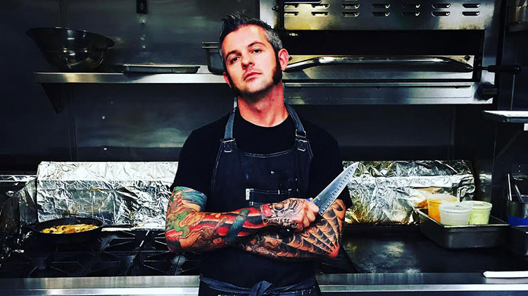 Jason Snyder a.k.a. the Renegade Chef posing in his kitchen.