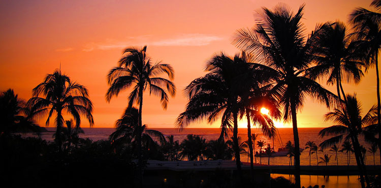 The sun sets on a Hawaii beach.