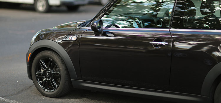 A Mini Cooper driving in Portland, Oregon's downtown district.