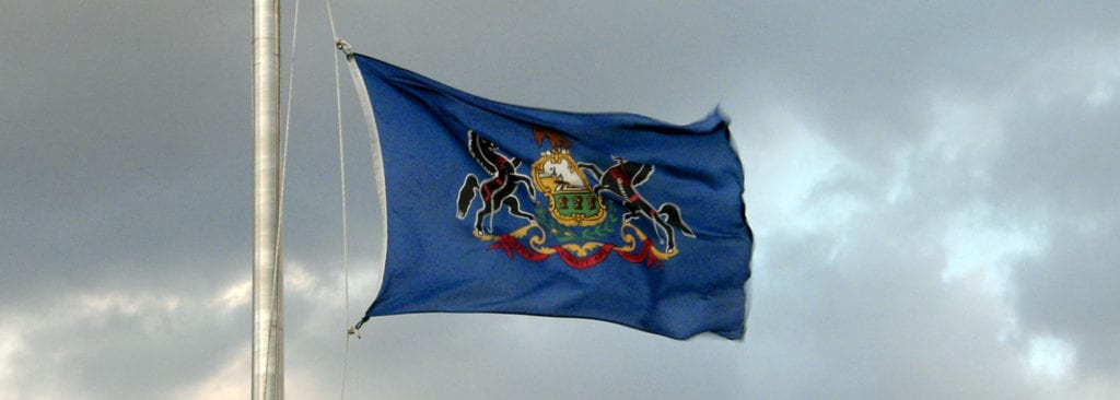 The state flag of Pennsylvania flying at the state capitol building.