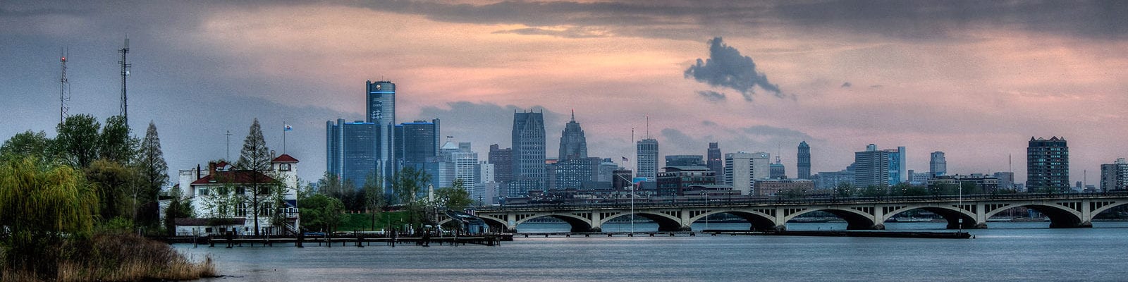 Detroit skyline with the MacArthur bridge leading to Belle Isle and Detroit Boat Club in the foreground. Photo taken from Belle Isle fishing pier.