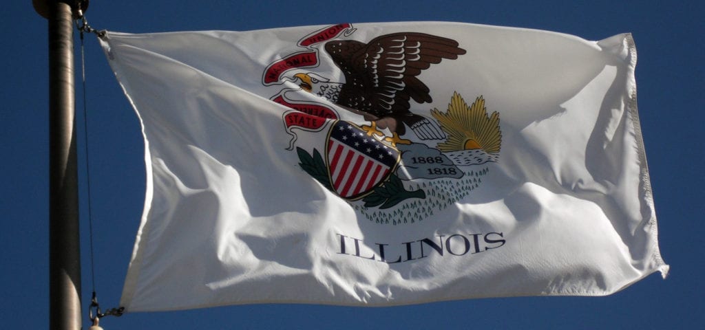 The state flag of Illinois flying on a clear day.