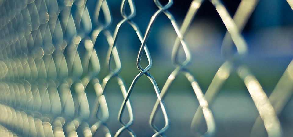 A prison chain-link fence.