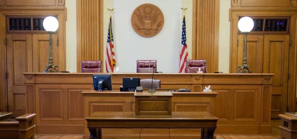 Empty judge's chair inside of a U.S. court room.