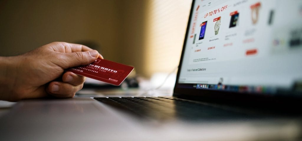 Using a credit card to make an online purchase.