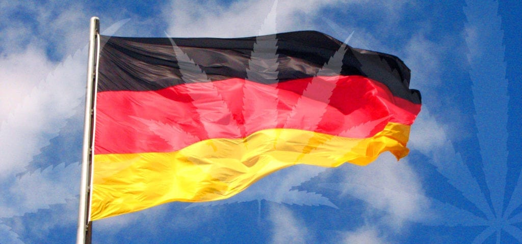 The flag of Germany with a misty cannabis leaf collage spliced over the top.