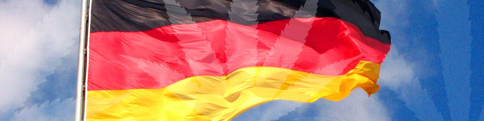 The flag of Germany with a misty cannabis leaf collage spliced over the top.