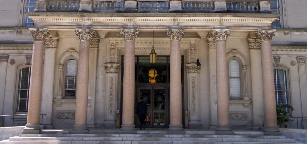 A man enters the front doors of the New Jersey State Capitol Building in Denton, New Jersey.