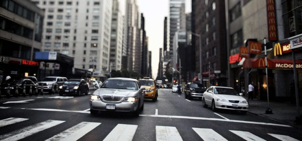 Cars driving on the streets of New York shortly before rush hour kicks in.