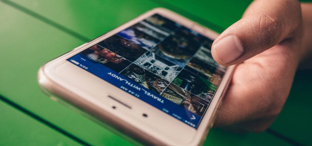 A Facebook user checks out a photo gallery using the Facebook phone app.