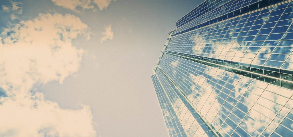 A skyscraper covered in glass windows.