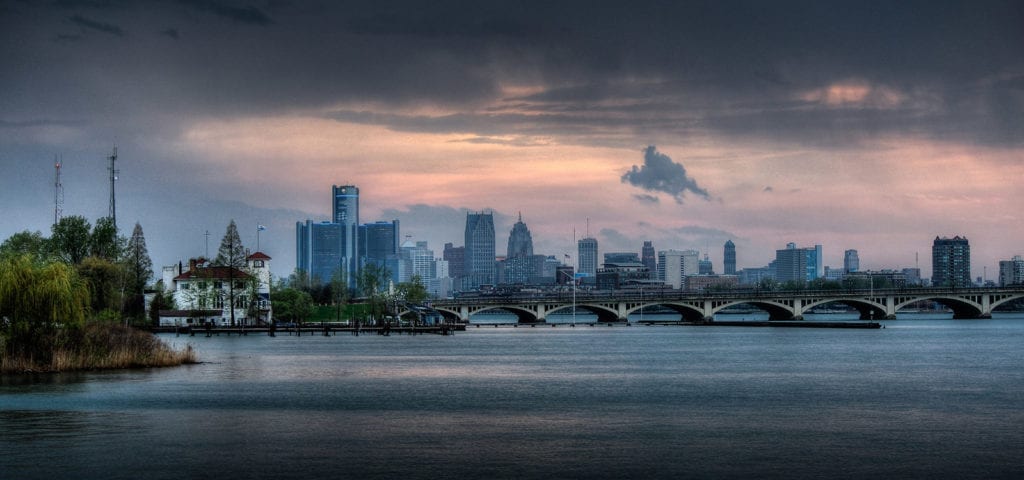 Detroit skyline with the MacArthur bridge leading to Belle Isle and Detroit Boat Club in the foreground.Detroit skyline with the MacArthur bridge leading to Belle Isle and Detroit Boat Club in the foreground.