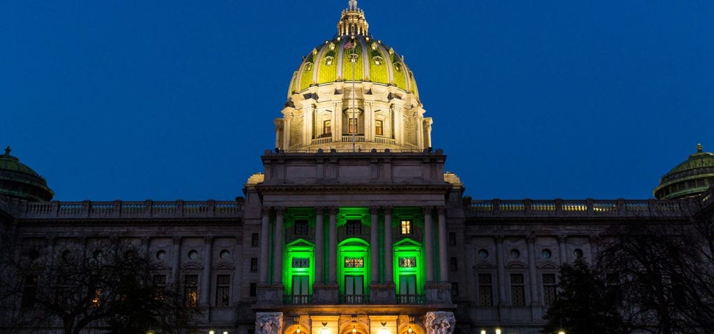 The Pennsylvania Capitol Building lit up with green lights to celebrate the House passage of the state's medical cannabis law in 2016.
