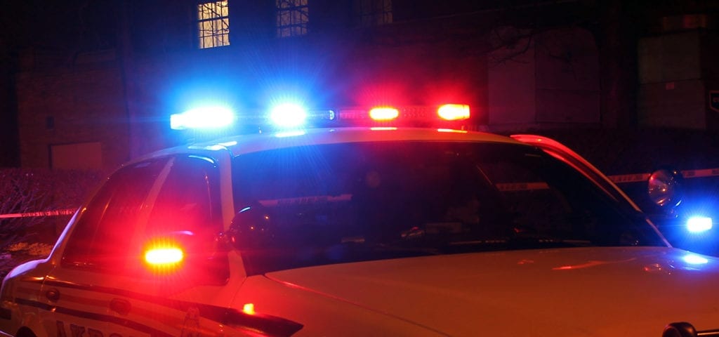 Red and blue lights on top of a police Crown Victoria cruiser.