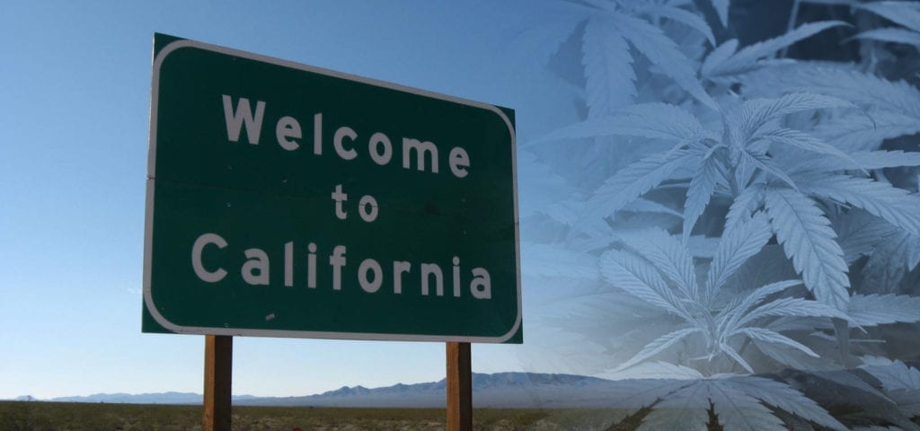 A roadside highway sign welcoming drivers to the state of California.