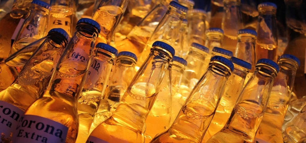 Bottled Corona beer inside of an ice-filled cooler.