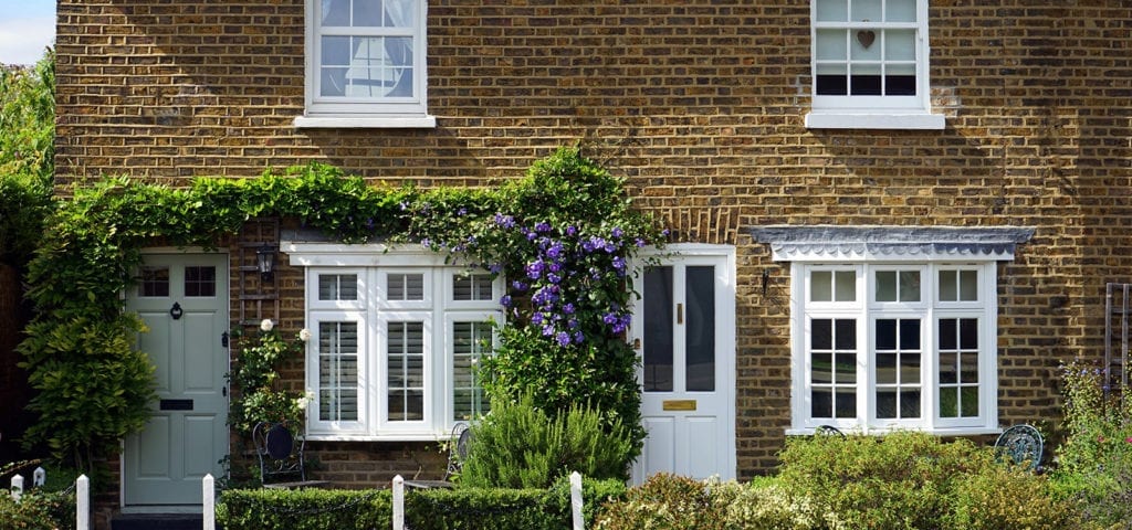 The front door of a tidy, rural country house.