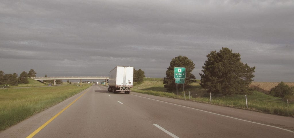 The long, straight stretch of road typical to Nebraska highway driving.