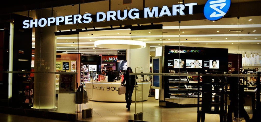 A woman walks into a Shoppers Drug Mart pharmacy, a department store chain in Canada.