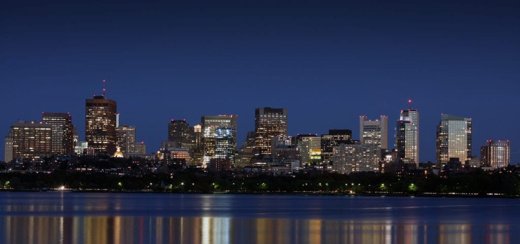 The Boston city skyline taken from a boat in the nearby harbor.