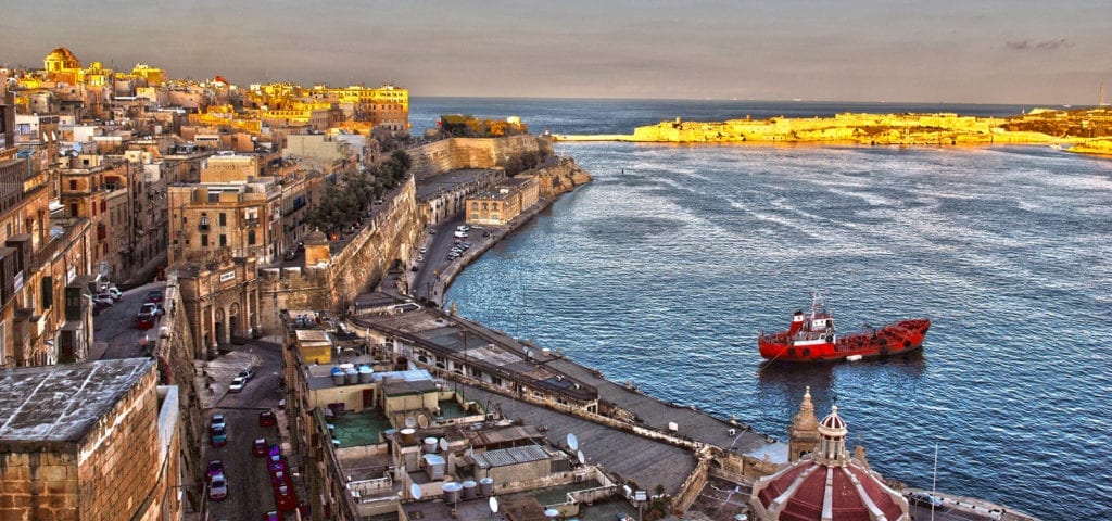 Sunset photo of the bay behind Valletta — Malta's capital city.