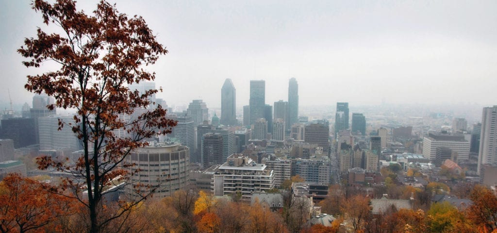 View of Montreal, Quebec from a faraway hillside on a foggy day.