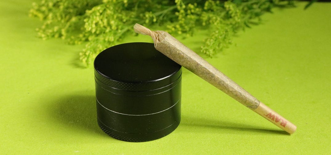 pre-roll cannabis joint and grinder